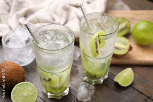 Glasses of refreshing drink with kiwi on table, closeup