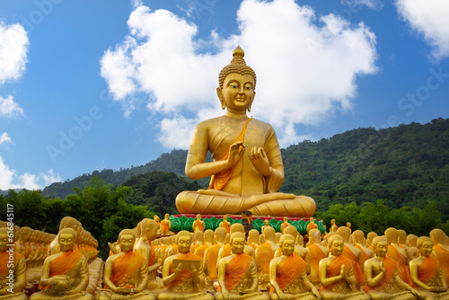 Big golden Buddha statue among small 1,250 Buddha statue at Makha Bucha Buddhist memorial park at nakhon nayok province, Thailand photo
