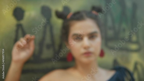 feminist frida kahlo inspired look, red earrings, serious pose, eye contact, looking into camera, young gen z female, emancipation, politics, culture, paradigm shift, emancipate women, feminism.  photo