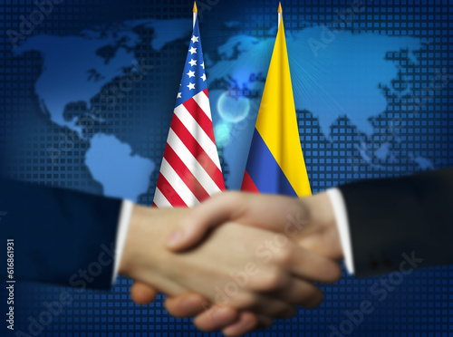 Фотография Two person shaking hands in front American,Colombian flags