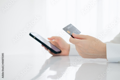 Fototapeta Naklejka Na Ścianę i Meble -  Cropped image of business lady using credit card to pay for online purchase