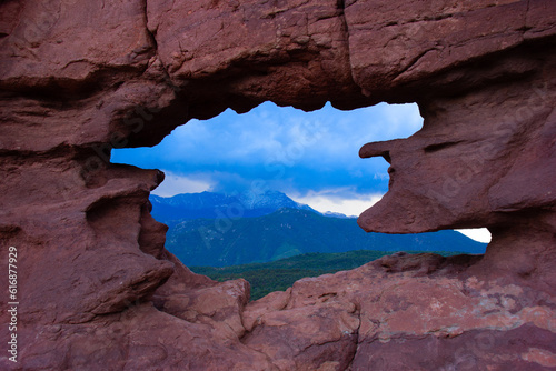 Garden of the Gods national park Keyhole Window with Pikes Peak in the spring with lush green forest trees in Colorado Springs, CO USA. photo