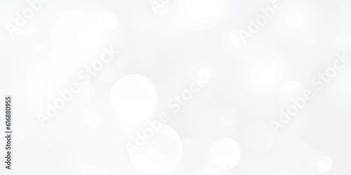 Abstract silver bokeh background with white light at center. The bokeh on the white background blurred the natural gray and white. Bokeh colorful glows sparkle.