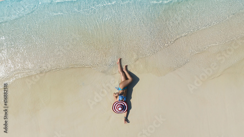 Summer and Relaxing lifestyle young woman lying and sunbathing on the beach