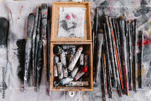 Artist utensils on smeared cloth. Brushes and pastels.