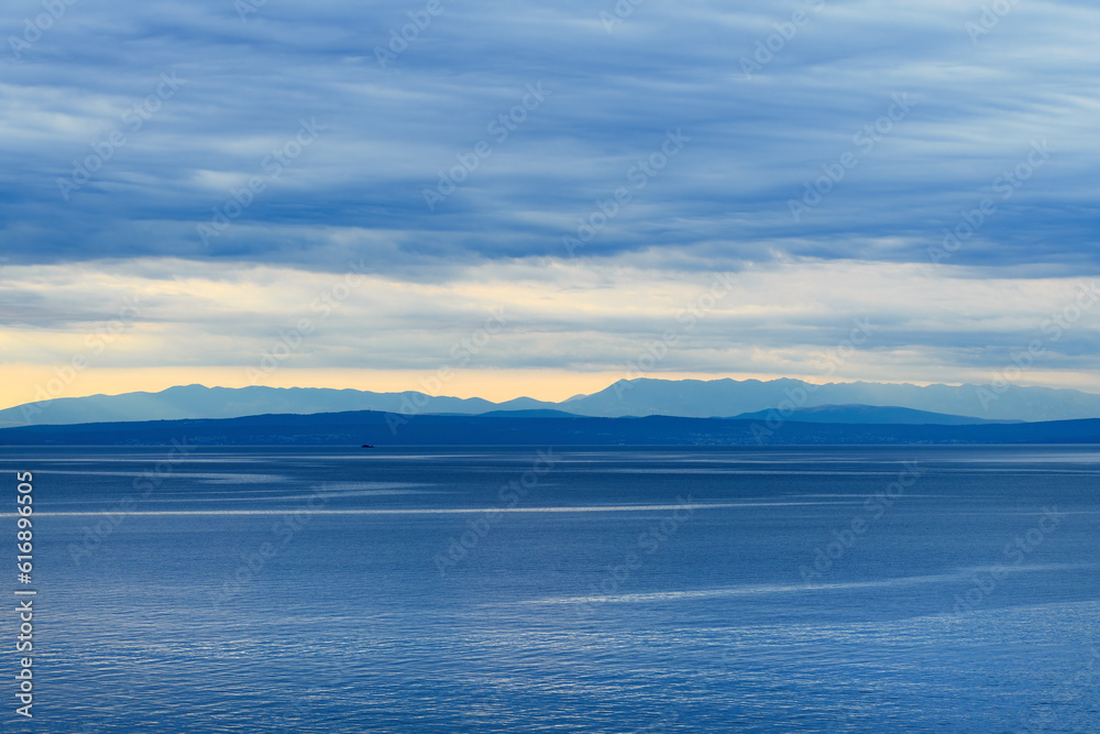 Overcast sky in morning at Kvarner gulf of Adriatic sea seen from croatian town of Lovran