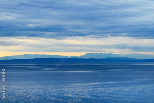 Overcast sky in morning at Kvarner gulf of Adriatic sea seen from croatian town of Lovran