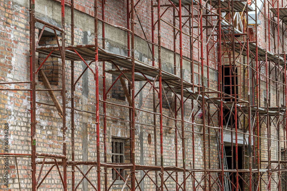 Scaffolding structure on construction site, renovation of an old industrial building