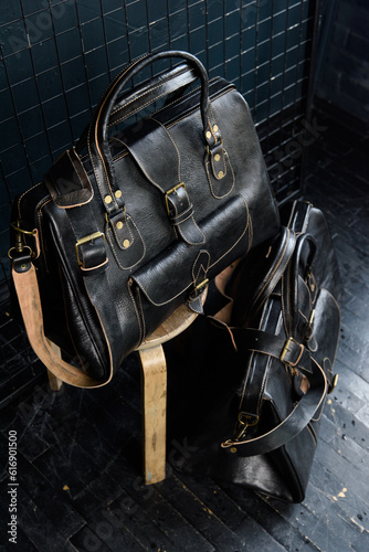 black leather travel bags indoors photo on black background