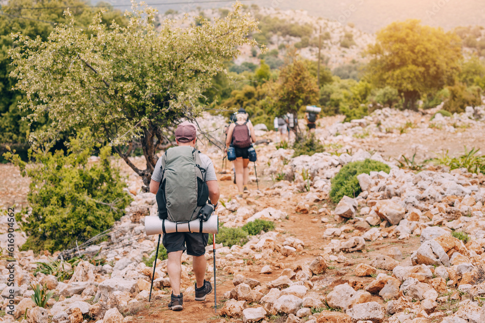 Group of hikers walking by the Lycian Way footpath in turkish countryside