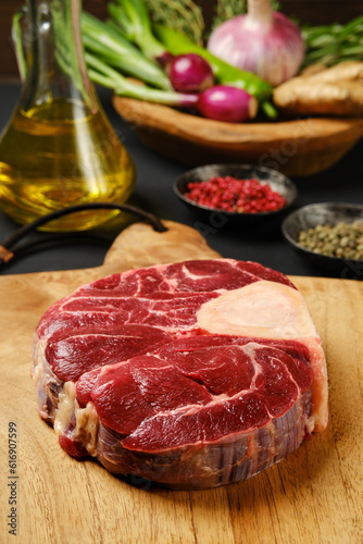 Closeup view of raw beef shank cross-cut on chopping board