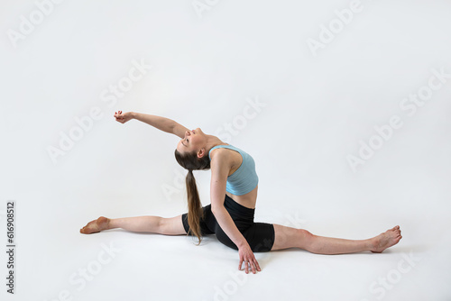Fototapeta Naklejka Na Ścianę i Meble -  Sporty young woman does yoga or pilates exercise