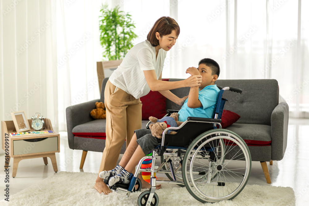 Portrait of asian physiotherapist carer helping and playing with disabled child health problem by doing exercises in rehabilitation clinic.disability care concept Portrait of asian physiotherapist carer helping and playing with disabled child health problem by doing exercises in rehabilitation clinic.disability care concept