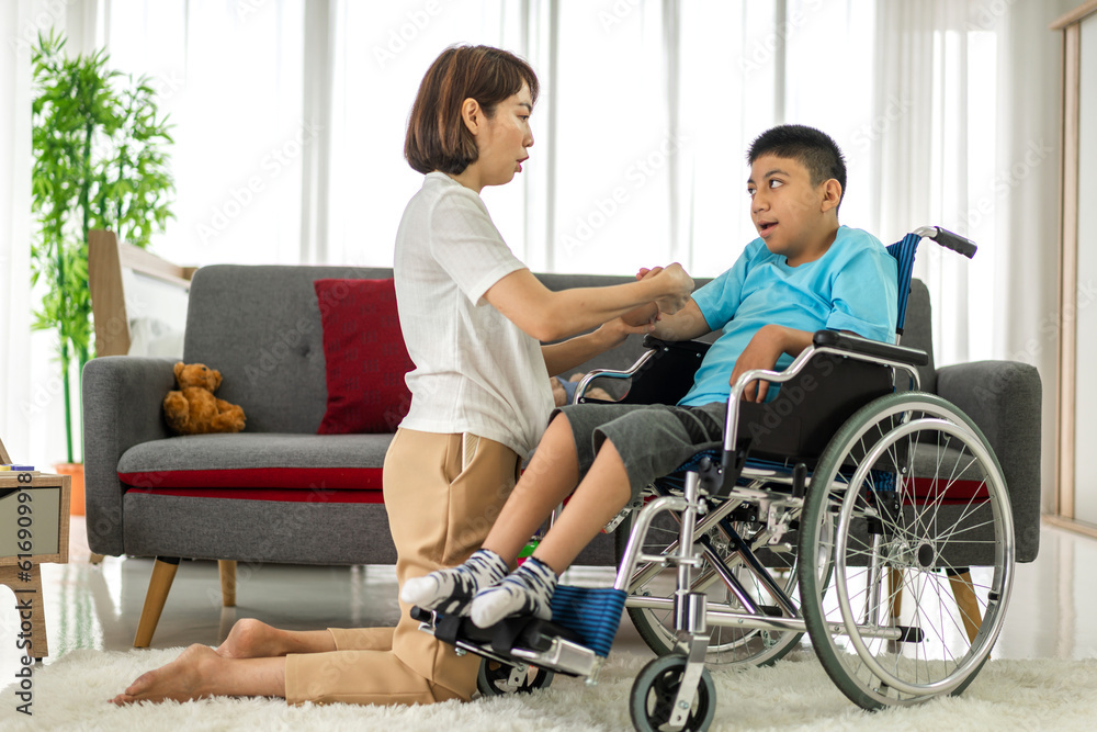 Portrait of asian physiotherapist carer helping and playing with disabled child health problem by doing exercises in rehabilitation clinic.disability care concept Portrait of asian physiotherapist carer helping and playing with disabled child health problem by doing exercises in rehabilitation clinic.disability care concept