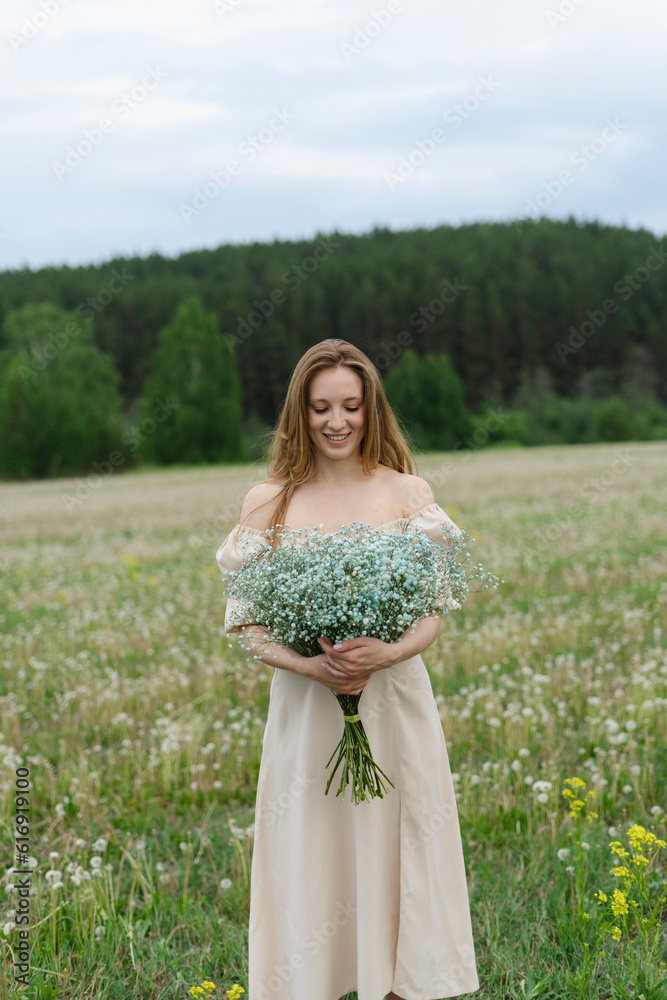 Smiling young woman holding flower bouquet on field Smiling young woman holding flower bouquet on field