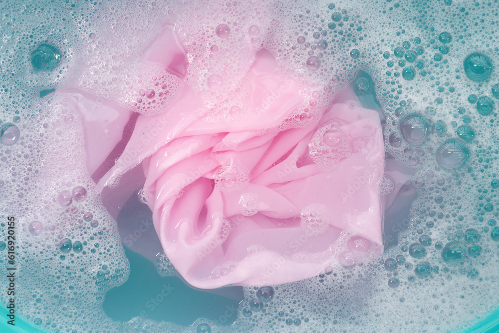 Clothes soak in powder detergent water dissolution, washing colored clothes Clothes soak in powder detergent water dissolution, washing colored clothes