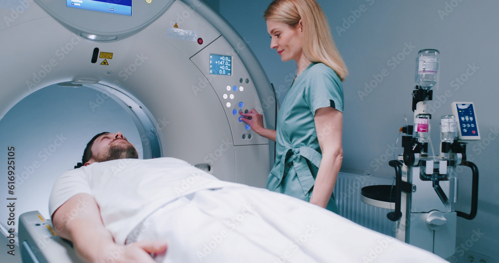 Patient is preparing for MRI examination. Man enters into MRI capsule ...