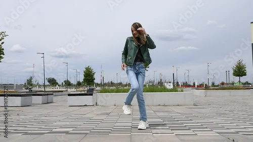 Young beautiful girl dancing modern dance on the street