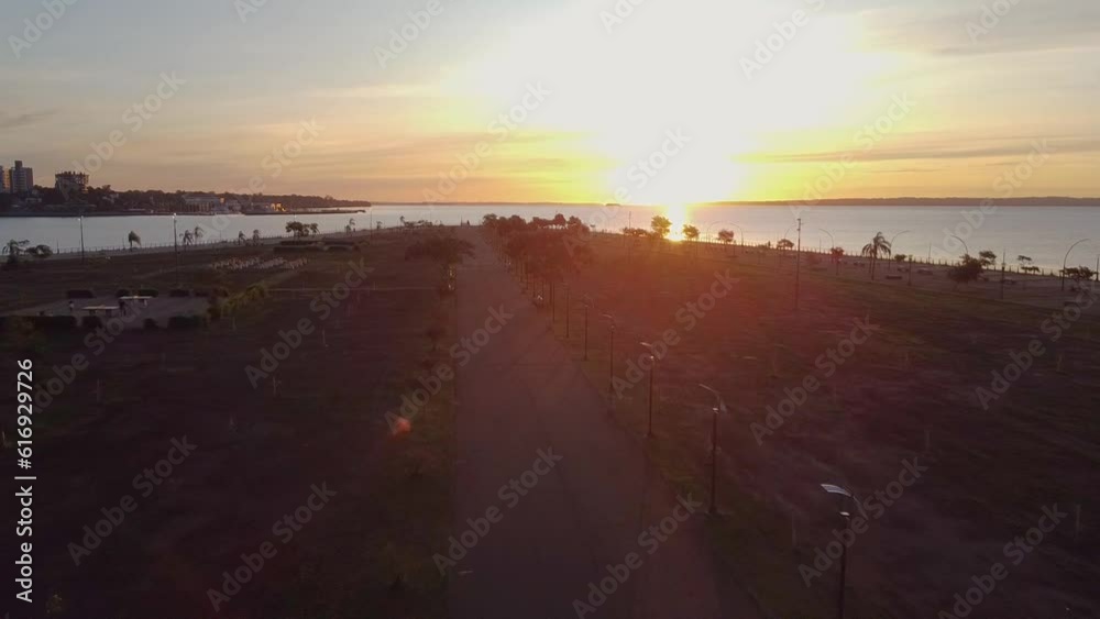 Aerial drone shot revealing the beautiful beach while sunset with a walkway Aerial drone shot revealing the beautiful beach while sunset with a walkway