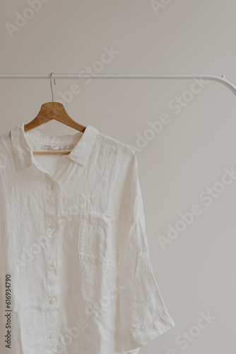 Minimal fashion clothes concept. Female blouse on hanger over white wall. Elegant fashion blog, magazine, website, social media concept