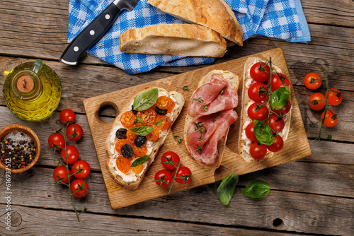 Принти на полотні Sandwich set of bruschetta with juicy tomatoes, cheese and prosciutto