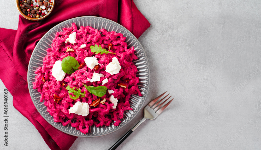 Naklejka premium Pasta with Beet Sauce, Vegetarian Beetroot Pasta, Pink Pesto, Tasty Healthy Meal