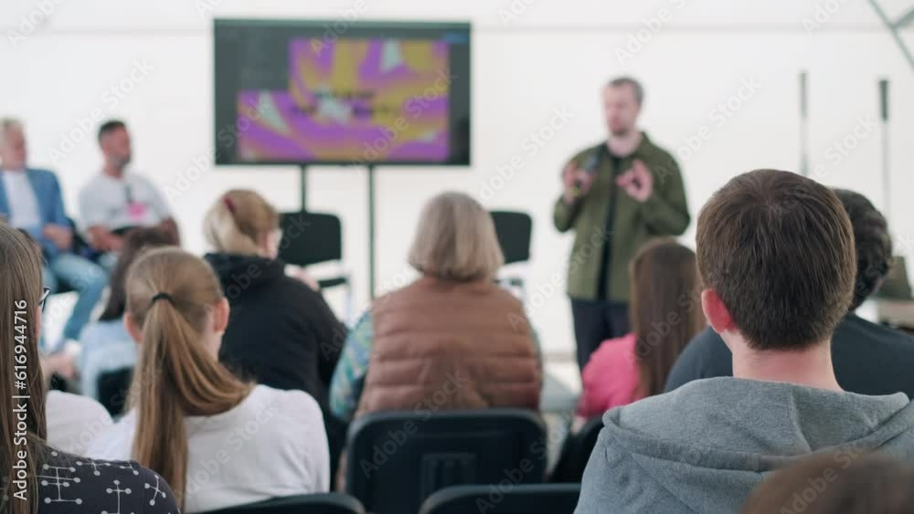Man giving presentation for audience during seminar Man giving presentation for audience during seminar