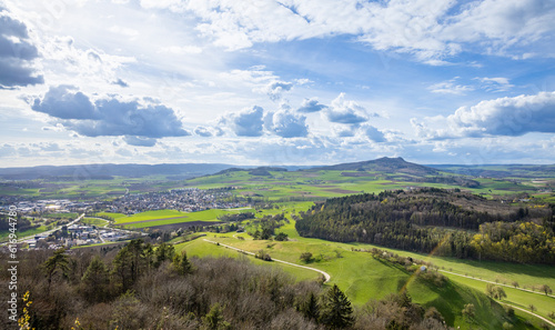 A town with roads, fields, pastures against the backdrop of silhouettes of hills and a cloudy sky photo