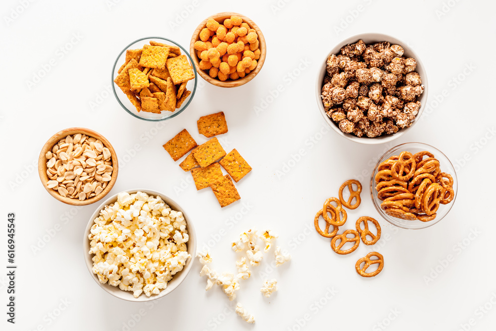 Bowls with different salty snacks for party. Fast food background Bowls with different salty snacks for party. Fast food background