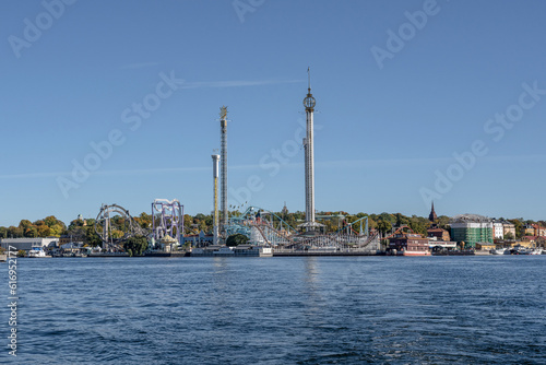 View of amusement park Grona Lund with carousels and tour rides on Djurgarden island Stockholm Sweden