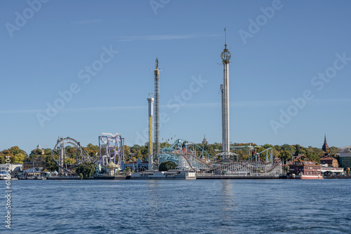 View of amusement park Grona Lund with carousels and tour rides on Djurgarden island Stockholm Sweden