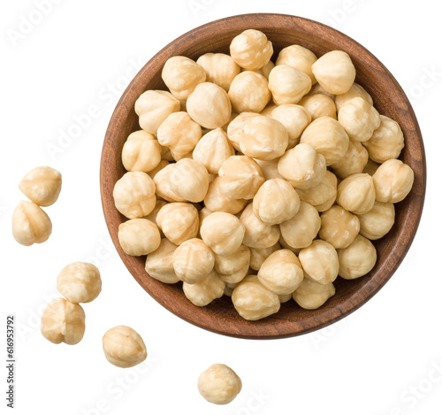 Hazelnuts in the wooden bowl, isolated on the white background, top view. photo