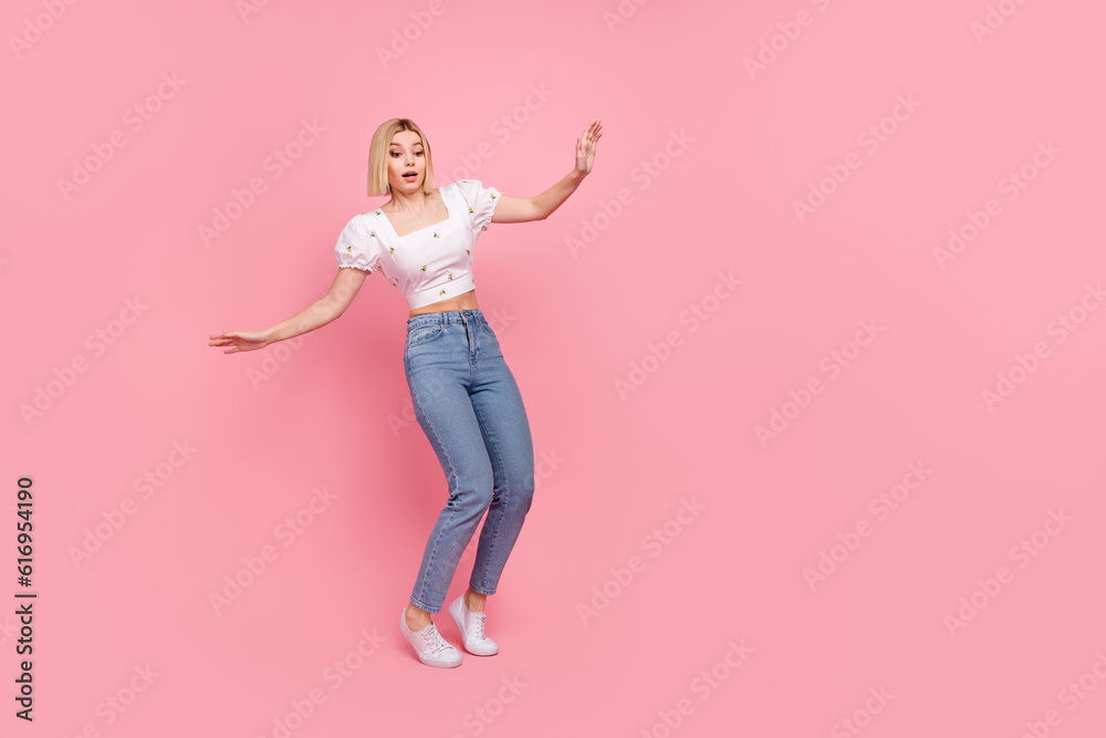 Full length legs cadre of young woman stay tiptoes frightened stressed balancing empty space abyss isolated on pink color background Full length legs cadre of young woman stay tiptoes frightened stressed balancing empty space abyss isolated on pink color background