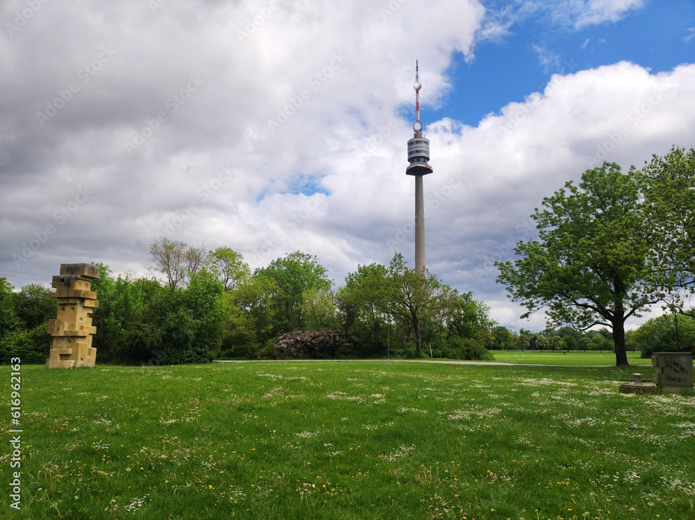 view of the Danube Tower in Vienna with cloudy sky in the background