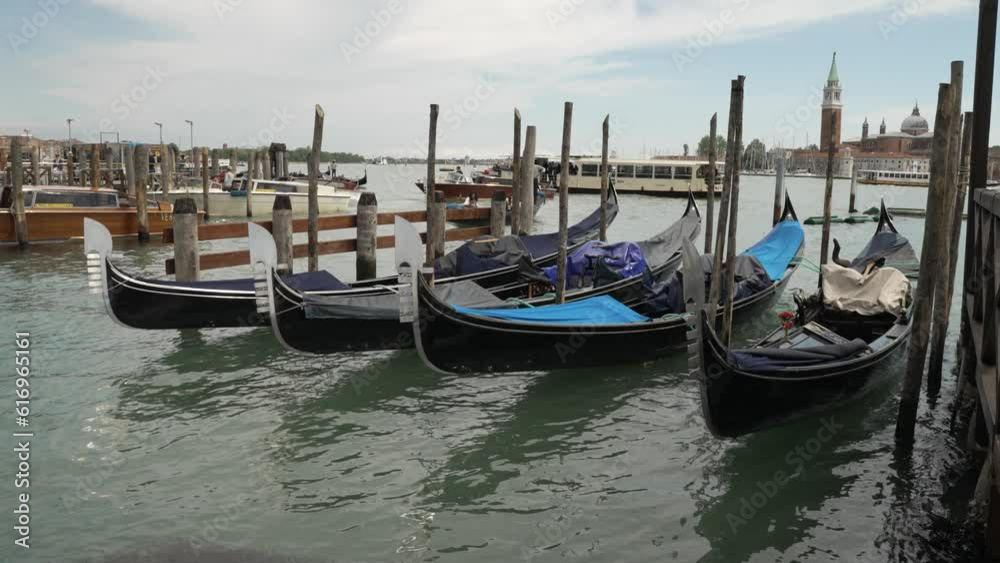 Venice Grand Canal scene, close up of Gondolas boats floating with view of city Venice Grand Canal scene, close up of Gondolas boats floating with view of city