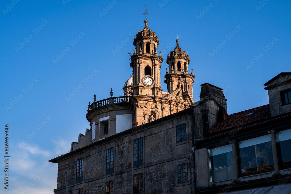 Bell tower of the Pilgrim Virgin church between old buildings. Photograph taken in Pontevedra, Galicia, Spain.