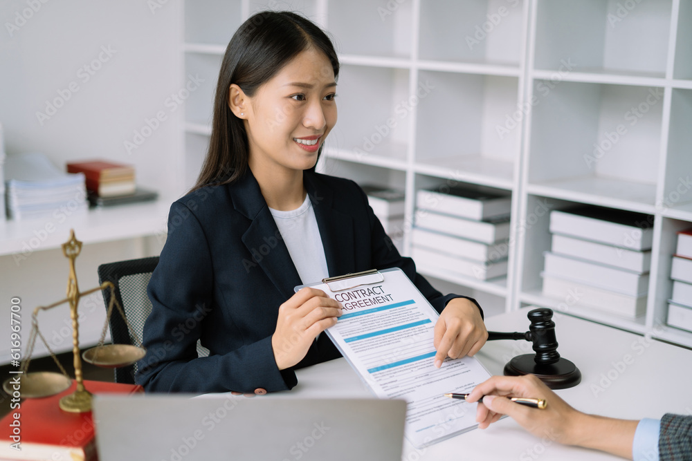 Legal counsel presents to the client a signed contract with legal law. justice and lawyer concept in office. Legal counsel presents to the client a signed contract with legal law. justice and lawyer concept in office.