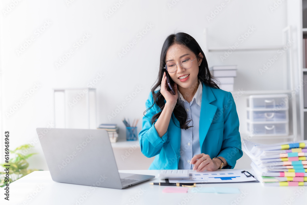 Asian businesswoman modern professional talking with client on the phone with a confident demeanor and effective communication skill. business, marketing, sale and communication project. Asian businesswoman modern professional talking with client on the phone with a confident demeanor and effective communication skill. business, marketing, sale and communication project.