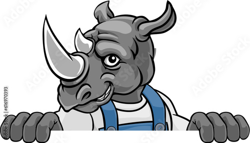 A rhino cartoon animal mascot gardener, carpenter, handyman, decorator or builder construction worker peeking around a sign