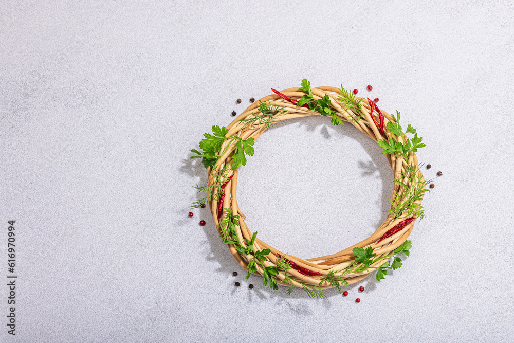 Fototapeta premium Culinary wreath with fresh greens, chili and peppercorn. Round frame, place for text, flat lay