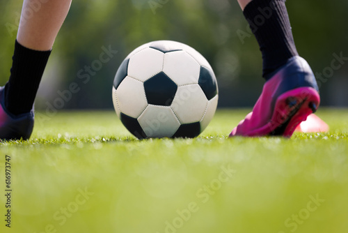 Youth Football Background. Young Boy Wearing Soccer Cleats and Soccer Socks. Player Kicking Classic Soccer Ball