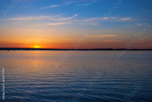 Sunrise over the horizon on Lake Seliger in Russia photo