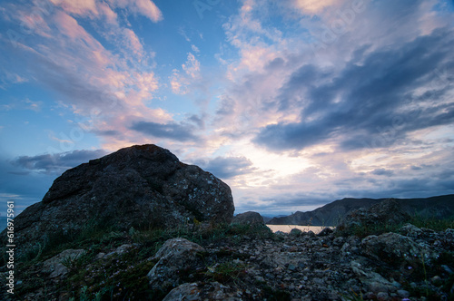 Beautiful landscape with big rocks against cloudy sky.