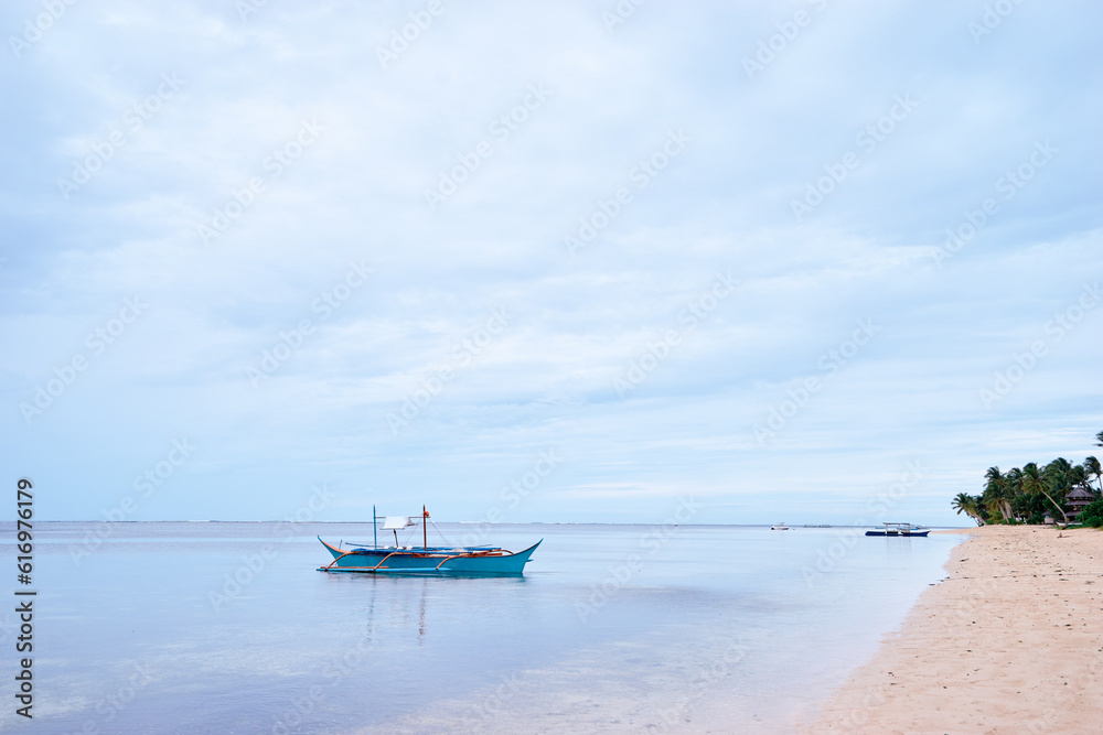 Beautiful landscape with tropical white sand beach with fishing boats. Siargao Island, Philippines. Beautiful landscape with tropical white sand beach with fishing boats. Siargao Island, Philippines.