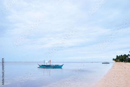 Beautiful landscape with tropical white sand beach with fishing boats. Siargao Island  Philippines.