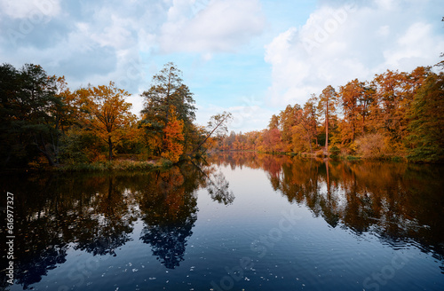 Colors of fall. Beautiful autumn landscape with forest and lake. © luengo_ua