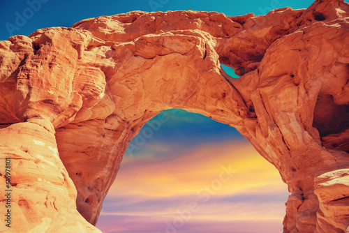Arch in the rock against colorful sunset sky. Desert nature landscape. Timna Park. Israel photo