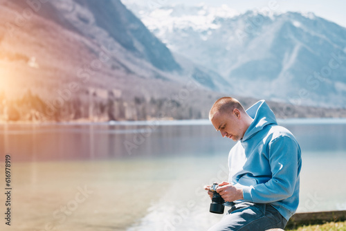 A Male Photographer Immersed in the Stunning Alpine Mountains. The photographer outdoors.