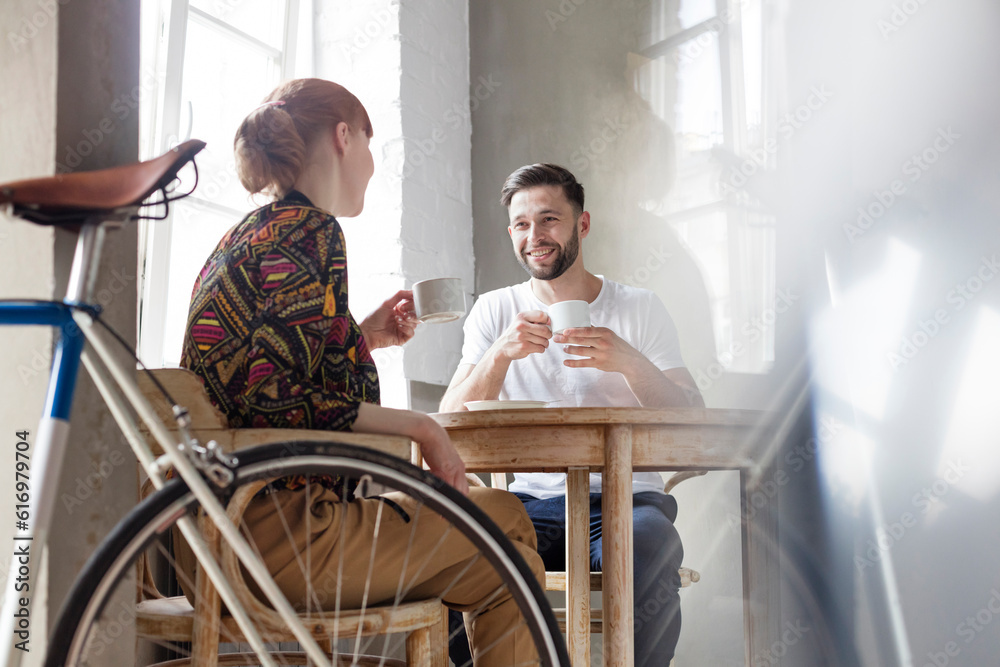 Couple talking and drinking coffee at table