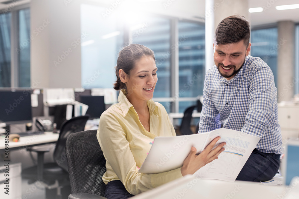 Business people reviewing paperwork in office